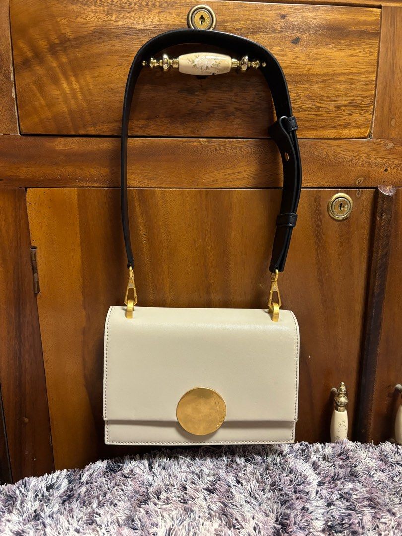 Oryany (Category: Luxury Bags & Wallets) located in Imus. Submitted by bagsofblessings24 (Listing ID 1334147904, Image 2). Description: Oryany kili/clutch leather bag Oryany is a luxury Korean brand Small size, light cream color Black wide strap Height 5.5 in x length 8 in Excellent condition Only flaw is the hairlines on the hardware ( pls see photo).