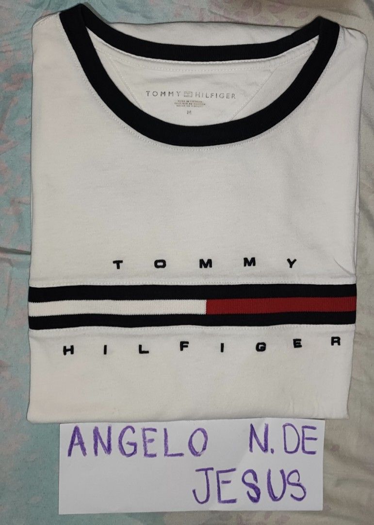 TOMMY HILFIGER (Category: Tshirts & Polo Shirts ) located in Taguig. Submitted by adejesus21 (Listing ID 1334124765, Image 1). Description: 100% AUTHENTIC TOMMY HILFIGER SCRIPT SIZE MEDIUM ON TAG DIMENSION - 21 WIDTH 28 LENGHT COLOR - WHITE CONDITION - EXCELLENT TO NEW 9.7/10 PRICE - P1,149 SHIPPED LOCATION - TAGUIG MODE OF PAYMENT - GCASH / METROBANK.