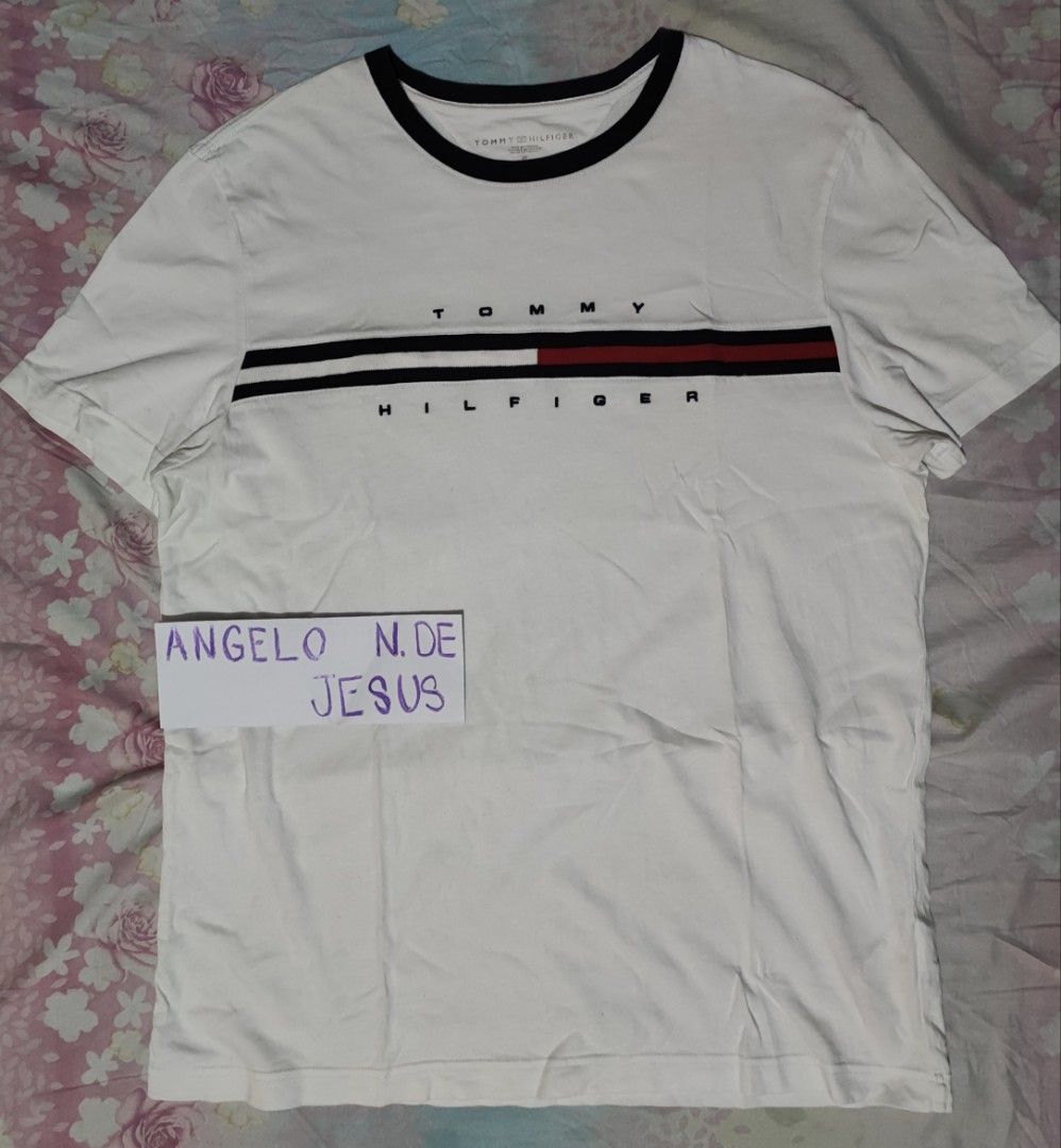 TOMMY HILFIGER (Category: Tshirts & Polo Shirts ) located in Taguig. Submitted by adejesus21 (Listing ID 1334124765, Image 2). Description: 100% AUTHENTIC TOMMY HILFIGER SCRIPT SIZE MEDIUM ON TAG DIMENSION - 21 WIDTH 28 LENGHT COLOR - WHITE CONDITION - EXCELLENT TO NEW 9.7/10 PRICE - P1,149 SHIPPED LOCATION - TAGUIG MODE OF PAYMENT - GCASH / METROBANK.