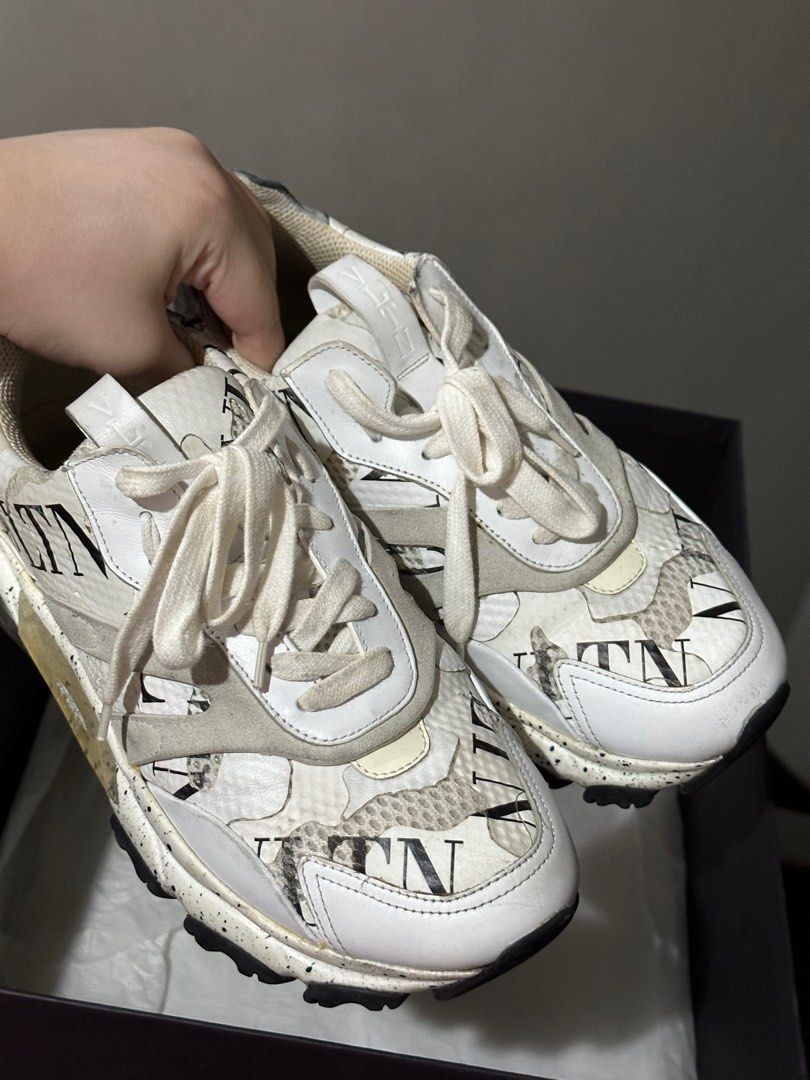 Valentino Trainers (Category: Sneakers & Footwear) located in Quezon City. Submitted by millennialdeclutterer (Listing ID 1334180932, Image 1). Description: 100% authentic Valentino Sneakers in color white & gray. Size EU38 (mens) fits US 8/9 womens. Bought at Holt Renfrew Canada for 976cad plus tax, roughly 45k last 2019. Complete inclusions w/ box, dust bag & care cards. Condition is 7/10 needs cleaning 😊.