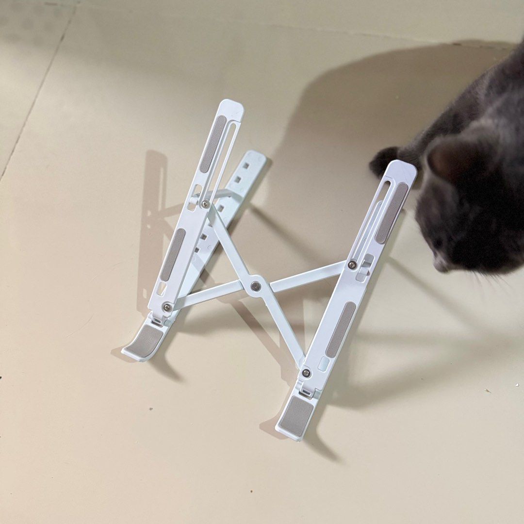 white & gray foldable laptop stand (Category: Laptop Bags & Sleeves) located in Antipolo. Submitted by bananadeclutter (Listing ID 1334182118, Image 3). Description: cat is not included material: plastic.