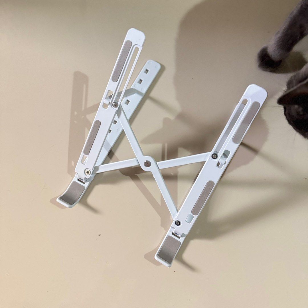 white & gray foldable laptop stand (Category: Laptop Bags & Sleeves) located in Antipolo. Submitted by bananadeclutter (Listing ID 1334182118, Image 1). Description: cat is not included material: plastic.
