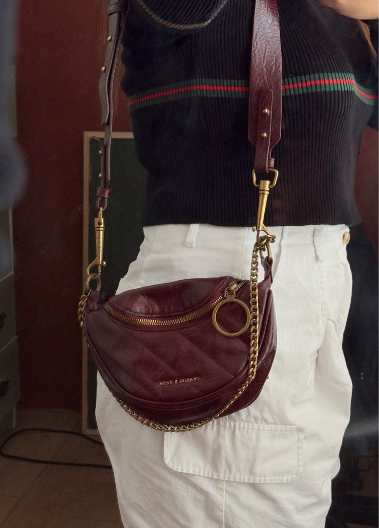 Charles & Keith Philomena Half moon crossbody Bag (Category: Luxury Bags & Wallets) located in Rodriguez. Submitted by declutterwithshals. (Listing ID 1337270758, Image 3). Description: Charles & Keith Philomena Half moon crossbody Bag Color: Burgundy Condition: 8/10 Flaws shawn in photos Rfs: No longer using it Note: actual color of the product may slightly vary from the color of this photo due to lighting.