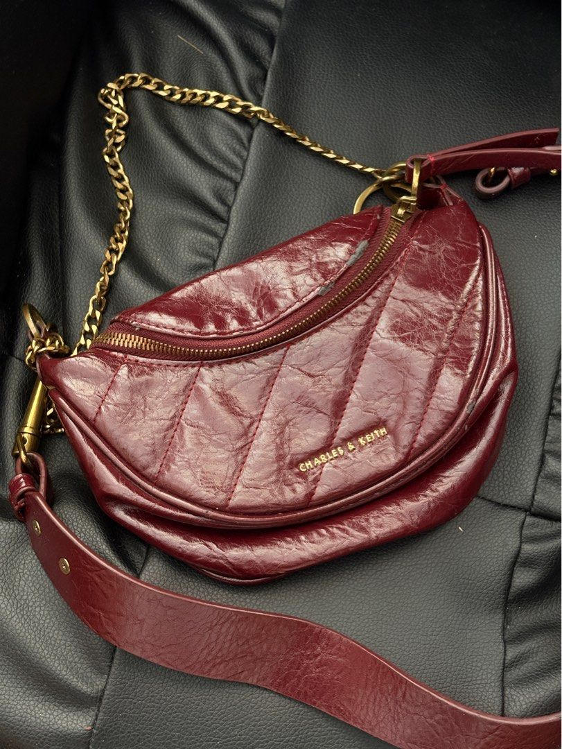 Charles & Keith Philomena Half moon crossbody Bag (Category: Luxury Bags & Wallets) located in Rodriguez. Submitted by declutterwithshals. (Listing ID 1337270758, Image 1). Description: Charles & Keith Philomena Half moon crossbody Bag Color: Burgundy Condition: 8/10 Flaws shawn in photos Rfs: No longer using it Note: actual color of the product may slightly vary from the color of this photo due to lighting.