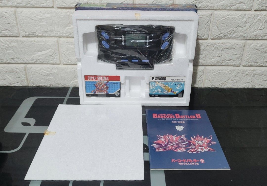 Epoch Conveni Wars Barcode Battler II (Category: Others) located in Caloocan City. Submitted by RetroGuild (Listing ID 1337371812, Image 3). Description: ✨Epoch Conveni Wars Barcode Battler II 🪙Price: •₱1,499 only 📦Included: •Unit (corroded battery port) •27 Cards •Box, Manual & Styro 📝Description: •Handheld console released in 1991 by Epoch; •Ideal for collectors of vintage handheld devices; •Unit has a corroded battery port; •Suitable for re
