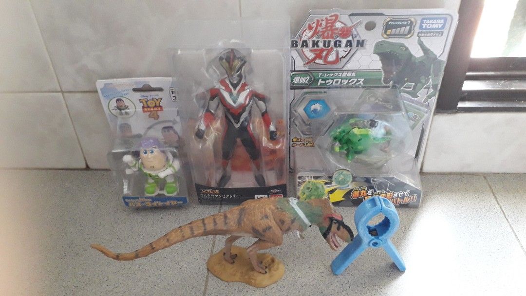 Toy Story, Ultraman and Bakugan (Category: Toy Figures) located in Singapore. Submitted by fruity007 (Listing ID 1337424742, Image 1). Description: Gifted. Take all for $12. Blue clothes peg for sizing..