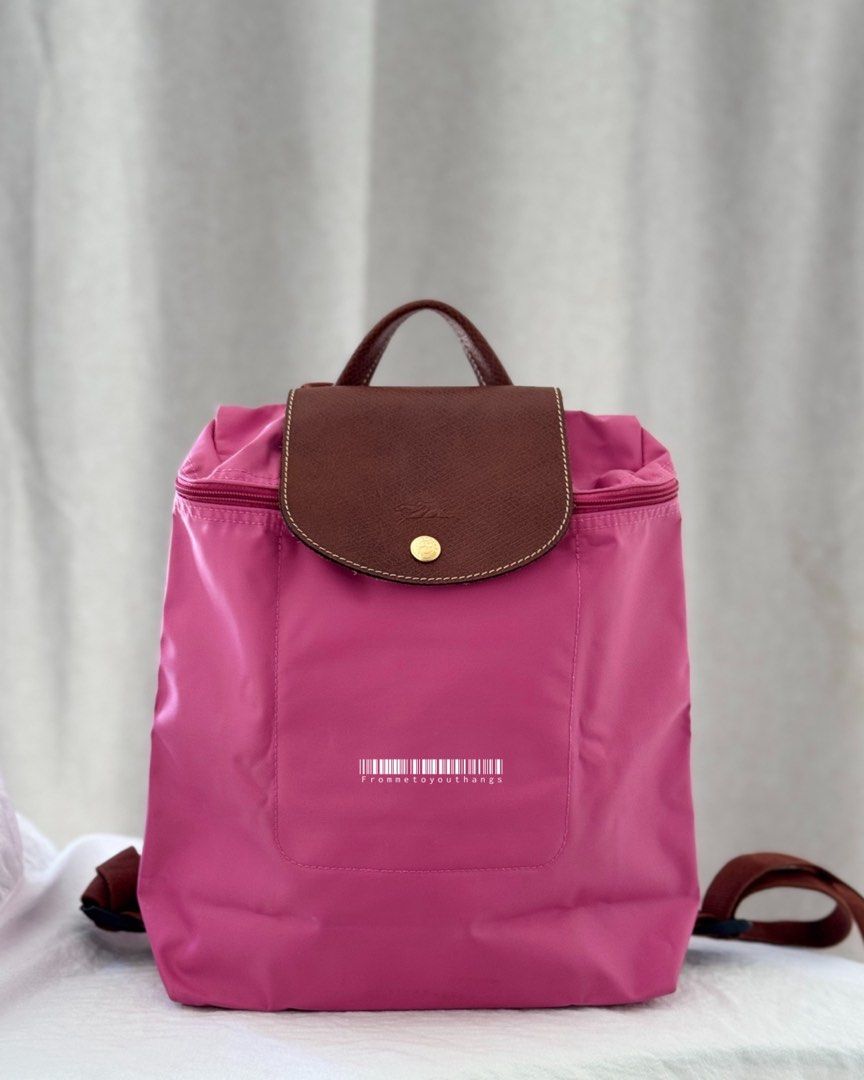 LONGCHAMP Le Pliage Backpack (Peony) (Category: Luxury Bags & Wallets) located in Cavite. Submitted by frommetoyouthings (Listing ID 1337432749, Image 1). Description: Excellent condition Discontinued seasonal colour Flaw/s: A bit of dirt on the interior of the bag and corner rubs. (Can be clean via DIY or a professional bag services. e.g Doctor Leather) Includes: care card Rustan's SRP: ₱9800.