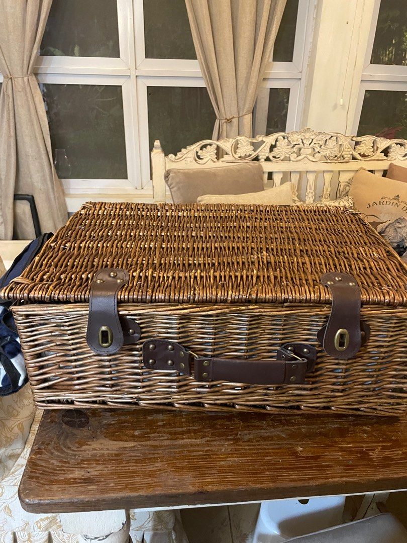 Picnic Basket (Category: Outdoor Furniture) located in Quezon City. Submitted by theabeatricee (Listing ID 1337524812, Image 1). Description: Picnic basket for 4 Contents: blue and white picnic mat, 4 glass plates, 4 sets of utensils (knife, spoon, fork), 4 wine glasses, 4 table napkins Material is wicker rattan.