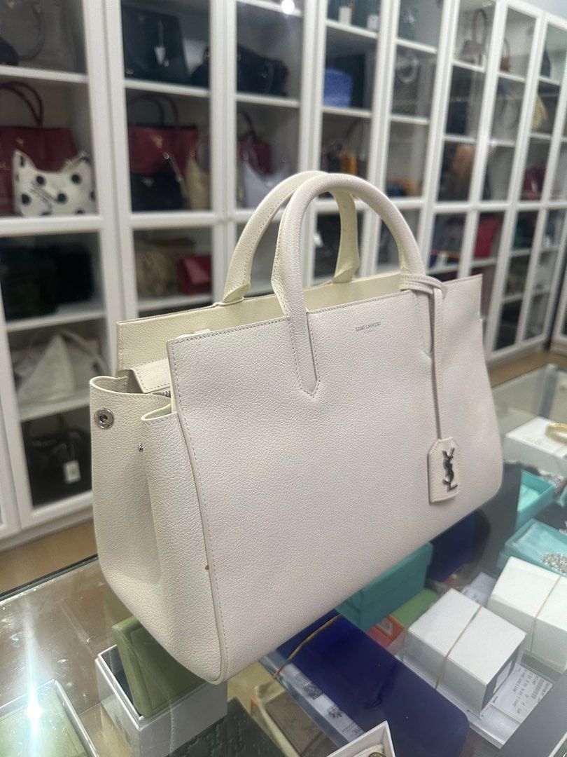 YSL Cabas Rive Gauche Medium Navy Leather Satchel (Category: Luxury Bags & Wallets) located in Taguig. Submitted by closetcompany (Listing ID 1337541524, Image 2). Description: YSL Cabas Rive Gauche Medium Navy Leather Satchel 🫧Php 60,000 🫧CONDITION: Very Good condition with usual signs of usage. Minor discoloration on some parts of the leather, adhesive stain on side, handles, and some parts of the leather trim & interior, and hairline scratch