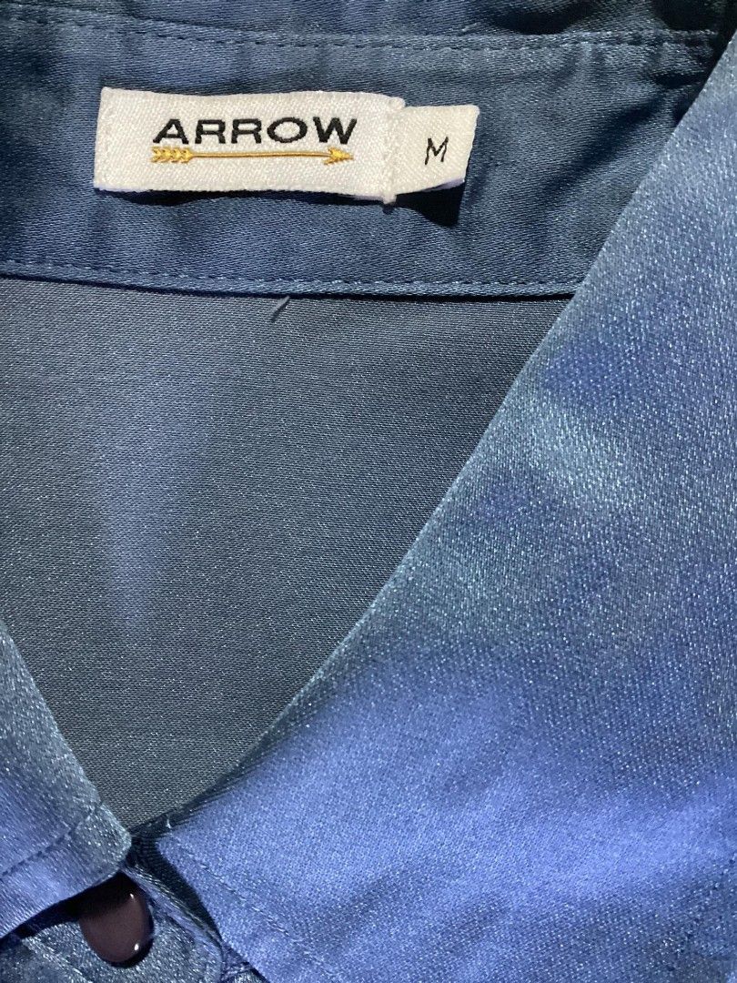 [Arrow] Satin Blue Button-Up Blouse (Category: Blouses) located in Pasig City. Submitted by kitcatss (Listing ID 1337927679, Image 2). Description: ☁️ Button-Up Blouse ☁️ Brand: Arrow Size: Medium on tag (best fits for sizes small and medium) Fabric: satin (parang silk) *No flaws *Original/ personal buy MOP: gcash/ paymaya MOD: j&t/ lalamove (sf shoulder by buyer) Rfs: decluttering (no longer worn) .