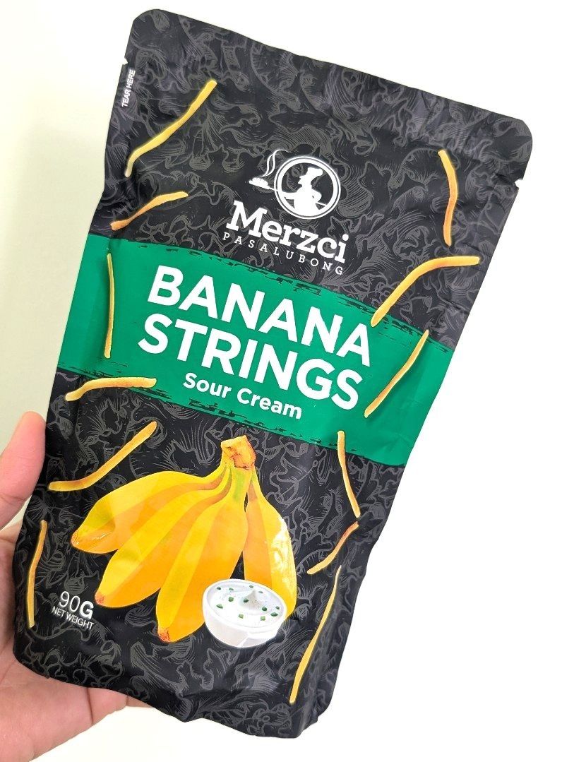 Banana Strings by Merzci (Category: Packaged & Instant Food) located in Makati City. Submitted by tiasetcetera (Listing ID 1337794219, Image 2). Description: Banana Strings by Merzci Pasalubong 📌 3 Flavors Available 🔸Sour Cream 🔸Cheese 🔸Barbeque Net Weight per pack : 90 grams Merzci is he trade name of CM&SONS FOOD PRODUCTS, INC. which was established in 1995. It is the leading bread and food pasalubong producer in Bacolod City and the island