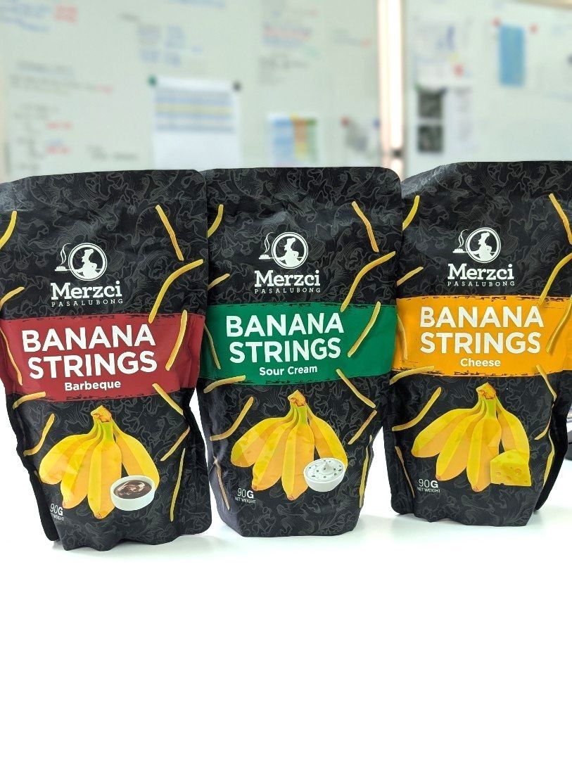 Banana Strings by Merzci (Category: Packaged & Instant Food) located in Makati City. Submitted by tiasetcetera (Listing ID 1337794219, Image 1). Description: Banana Strings by Merzci Pasalubong 📌 3 Flavors Available 🔸Sour Cream 🔸Cheese 🔸Barbeque Net Weight per pack : 90 grams Merzci is he trade name of CM&SONS FOOD PRODUCTS, INC. which was established in 1995. It is the leading bread and food pasalubong producer in Bacolod City and the island