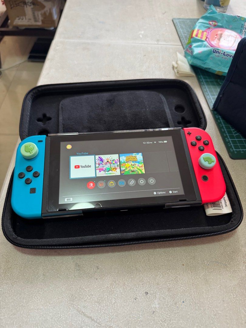 Nintendo Switch Ver.2 (Category: Nintendo) located in Pasig City. Submitted by crisbern23 (Listing ID 1337790776, Image 3). Description: Complete set with box Hardcase Additional Type C charger Physical Game- Just Dance 2019 Digital Game- Animal Crossing- New Horizon .