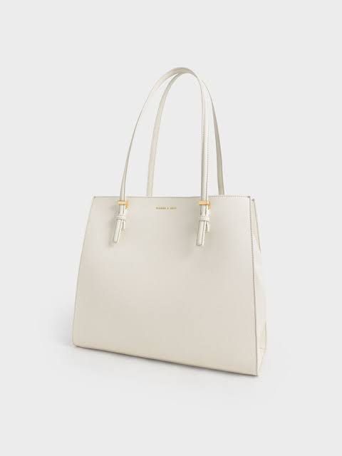 Charles and Keith Sansa Tote Bag (Category: Luxury Bags & Wallets) located in Quezon City. Submitted by mahliknvrr (Listing ID 1337941476, Image 1). Description: authentic charles and keith bag in cream white original price is 4,999 has minimal stains (as shown in the picture) slighty negotiable .