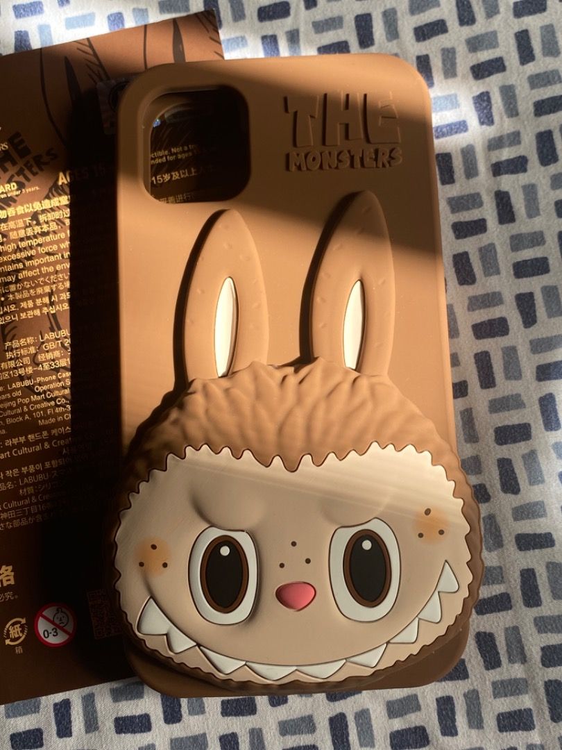PopMart x HOW2WORK Brown Labubu Phone Case iPhone 11 (Category: Cases & Sleeves) located in Paranaque City. Submitted by kerropimarch (Listing ID 1337985560, Image 3). Description: bought from popmart store in the US, no box/plastic cover but with authenticity card for iPhone 11, silicone case m unused .