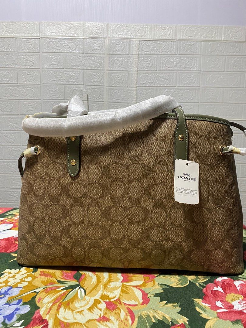 Authentic Coach Drawstring Caryall in Signature Canvas (with tag) (Category: Luxury Bags & Wallets) located in Manila. Submitted by mogsmogs (Listing ID 1338683622, Image 3). Description: Item is brand new with tag Authentic/ Original Material: Canvas Dimensions (HxWxD) : 9.5”x14.25”x6.25” .