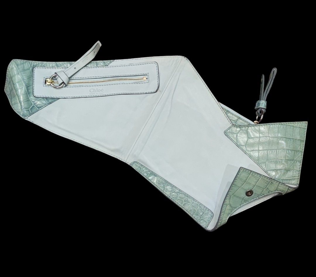 CHLOE Freja Origami Clutch (Category: Luxury Bags & Wallets) located in Digos. Submitted by emmanuel28 (Listing ID 1338475079, Image 3). Description: CHLOE Freja Origami Clutch OCEANBLUE COLOR CROCODILE SKIN EMBOSSED AUTHENTIC Made in ITALY Height: 10 inches Length: 11 inches ZIPPERS ARE WORKING SMOOTHLY BUTTONS SNAPS TIGHTLY ITEM HAS STAIN (PLS SEE 2ND TO THE LAST PHOTO) SLIGHTLY DISCOLORATION OF FADING DUE TO LEATHER NATURAL OXIDATION LOCATION: