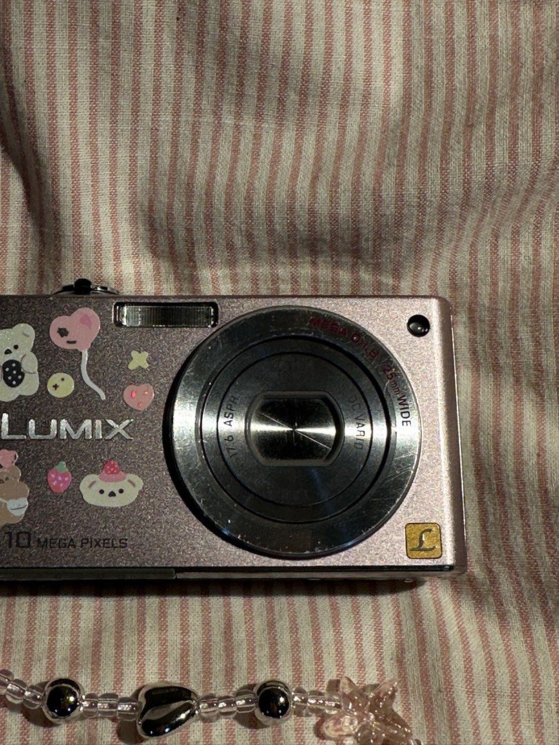 LUMIX DIGICAM DMC (Category: Cameras) located in Mandaluyong City. Submitted by madb888 (Listing ID 1338748297, Image 3). Description: NO FUNCTIONAL ISSUES‼️🙏 rare and cute light pink color 🙂‍↕️ INCLUSIONS : Camera unit Original Battery Strap.