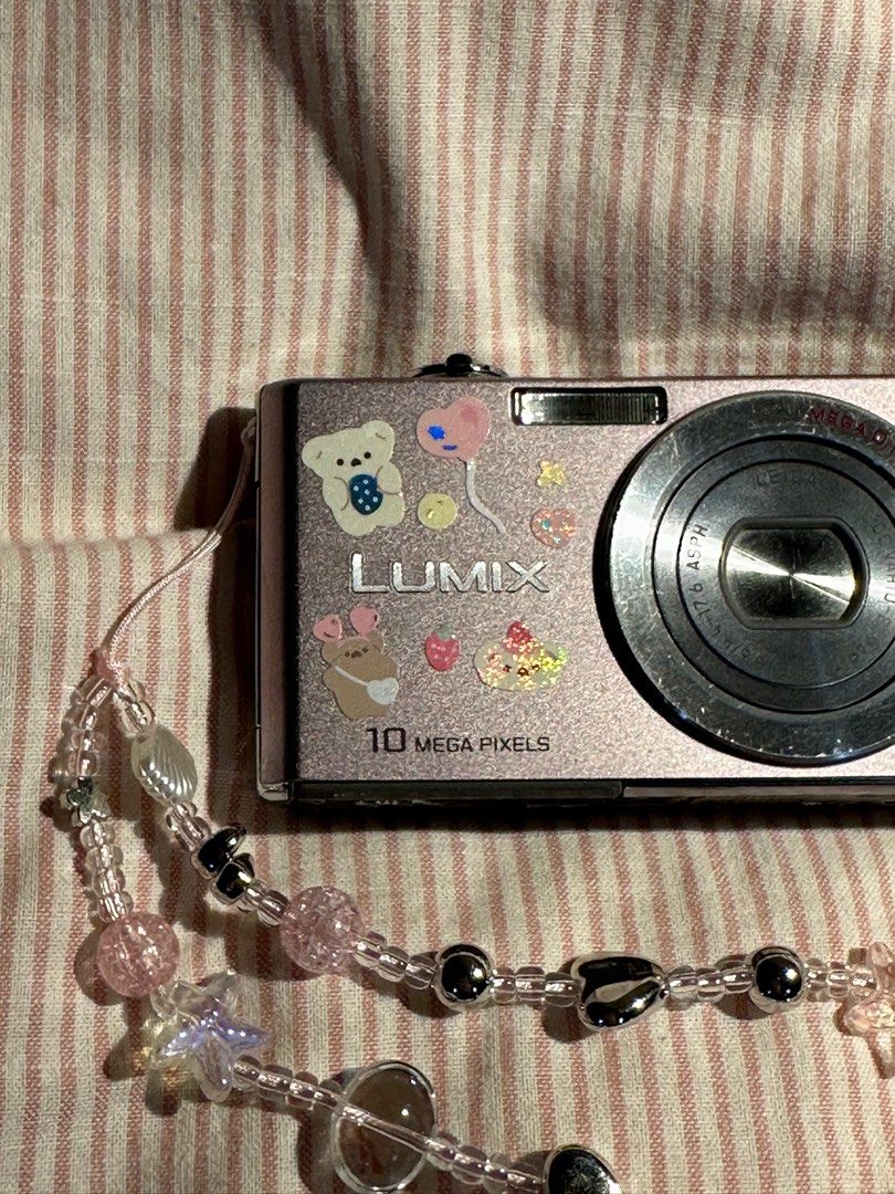 LUMIX DIGICAM DMC (Category: Cameras) located in Mandaluyong City. Submitted by madb888 (Listing ID 1338748297, Image 2). Description: NO FUNCTIONAL ISSUES‼️🙏 rare and cute light pink color 🙂‍↕️ INCLUSIONS : Camera unit Original Battery Strap.