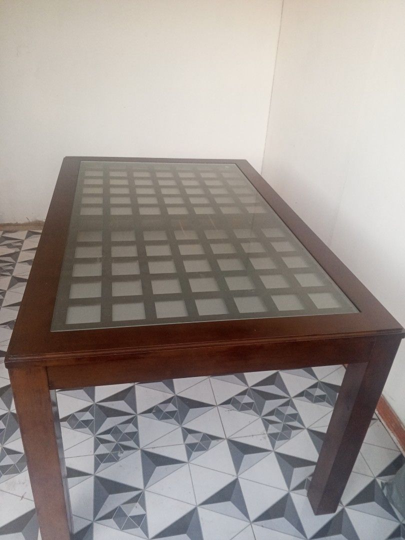 Solid Mahogany Wood Dining Table with Top Glass (Category: Tables & Sets) located in Rodriguez. Submitted by amara0914 (Listing ID 1338821399, Image 2). Description: FOR Sale Brand New Condition No Hidden Scratches 6 Seater Solid Mahogany Wood Dining Table 53 inches length 33 inches width 27 inches height.