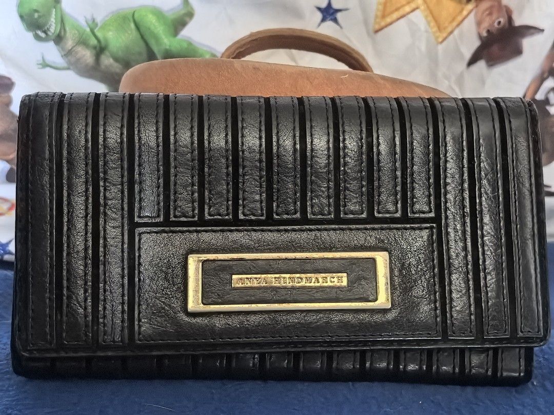 Anya Hindmarch long wallet (Category: Luxury Bags & Wallets) located in Quezon City. Submitted by uptrendglam (Listing ID 1338876089, Image 1). Description: Anya Hindmarch long wallet with 7 card slots, coin and 3 bill slots. Issue is on the hardware. Guaranteed authentic. Last price posted..