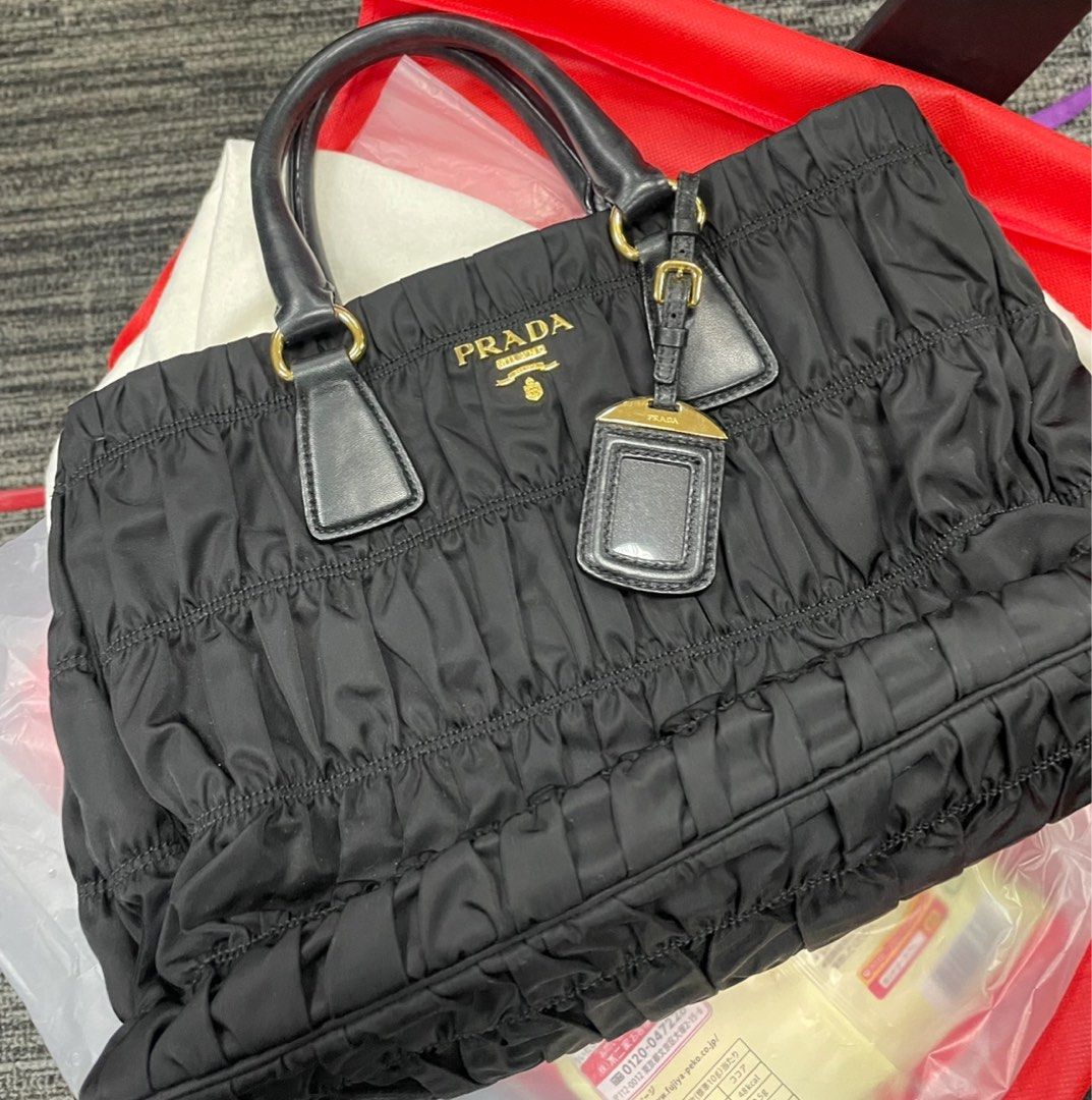 Prada nylon bag (Category: Luxury Bags & Wallets) located in Makati City. Submitted by prebykris (Listing ID 1338898209, Image 3). Description: Prada nylon bag (guaranteed authentic). RFS is I barely use it. It comes with dustbag, care card, and strap. All original! :).