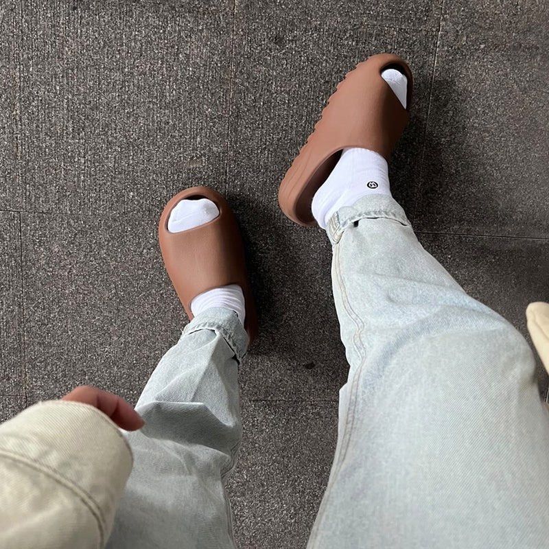 earth brown yeezy slides on feet