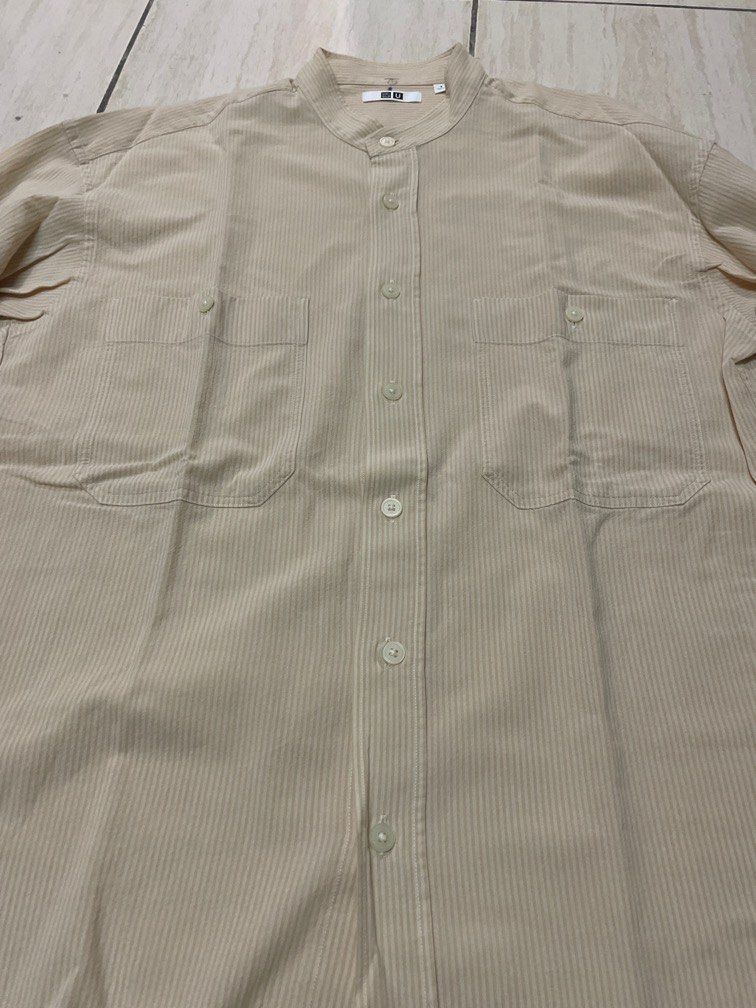Uniqlo Stand Collar Button down Long Sleeve Shirt (Category: Formal Shirts) located in Caloocan City. Submitted by sonner9728 (Listing ID 1334233140, Image 2). Description: Uniqlo Stand Collar Button down Long Sleeve Shirt Size on tag: Small Color: cream and white stripes Rfs: Decluttering Minor issue: number written on collar 250+Sf .
