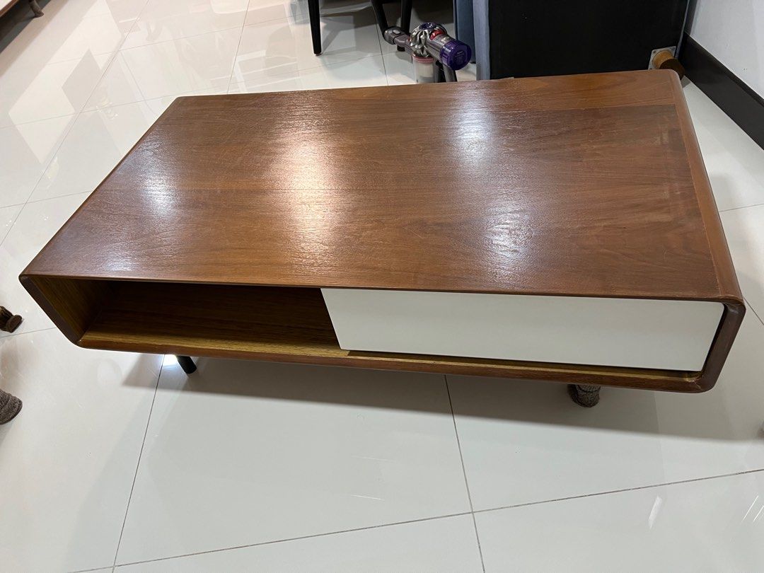 Solid Wood Coffee Table (Category: Tables & Sets) located in Singapore. Submitted by eesann (Listing ID 1338993754, Image 3). Description: Solid wood coffee table with two drawers and two open storage space. The dent at corner were caused by bad packaging during delivery. Used for two years and well maintained. Need two persons to move the table as it is quite heavy..