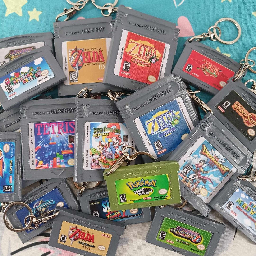 3D Printed Gameboy / Gameboy Advance Game Cartridge Keychains (Category: Character Goods) located in Muntinlupa City. Submitted by southrage (Listing ID 1334446036, Image 1). Description: 3D Printed Gameboy / Gameboy Advance Game Cartridge Keychains Game Cartridges Keychain Replica Materials: Filament PLA+ Water Based Acrylic Paint Waterproof Matte Sticker Available Designs: GBA: Golden Sun Megaman: Battle Network 2 Megaman: Battle Network 3 Whit