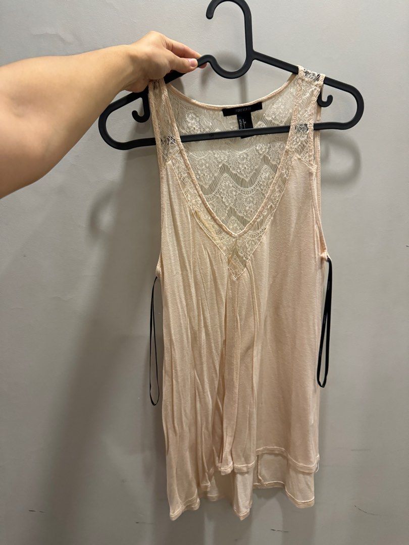 Forever 21 lace sleeveless top (Category: Sleeveless) located in Manila. Submitted by nikkimore (Listing ID 1334614348, Image 1). Description: Flowy, light. Light peach/pink. Rfs: decluttering.