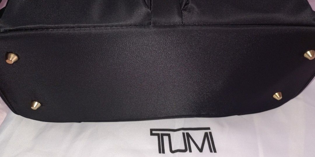 Tumi Nylon Travel bag (Category: Luxury Bags & Wallets) located in Makati City. Submitted by xie10474 (Listing ID 1334571281, Image 3). Description: Spacious with lots of pockets for travel Size: 38×26×15cm With back pocket that can turn to luggage holder/strap Soft inner lining backing for ipad/tablet With original dust bag & hang tag Double-zipper, gold hardware Adjustable strap No barcode RFS: Decluttering; Used twice.
