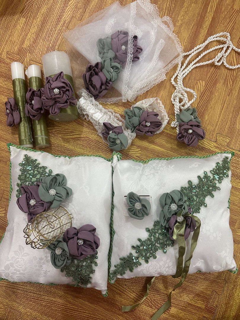 Wedding essentials - mauve/sage green (Category: Other Accessories) located in Las Pinas. Submitted by mariztelpv (Listing ID 1334588892, Image 1). Description: Ring pillow Arrhae pillow with arrhae holder 3-pc candle set 1 match Leg garter Wedding cord Secondary veil Bible garter.