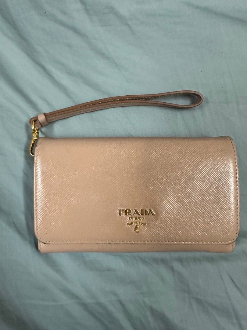 Prada Wristlet (Category: Luxury Bags & Wallets) located in Quezon City. Submitted by juliaatherese (Listing ID 1334729687, Image 2). Description: Shows signs of usage and cloth at back zipper ripped. Refer to last photo for issue..