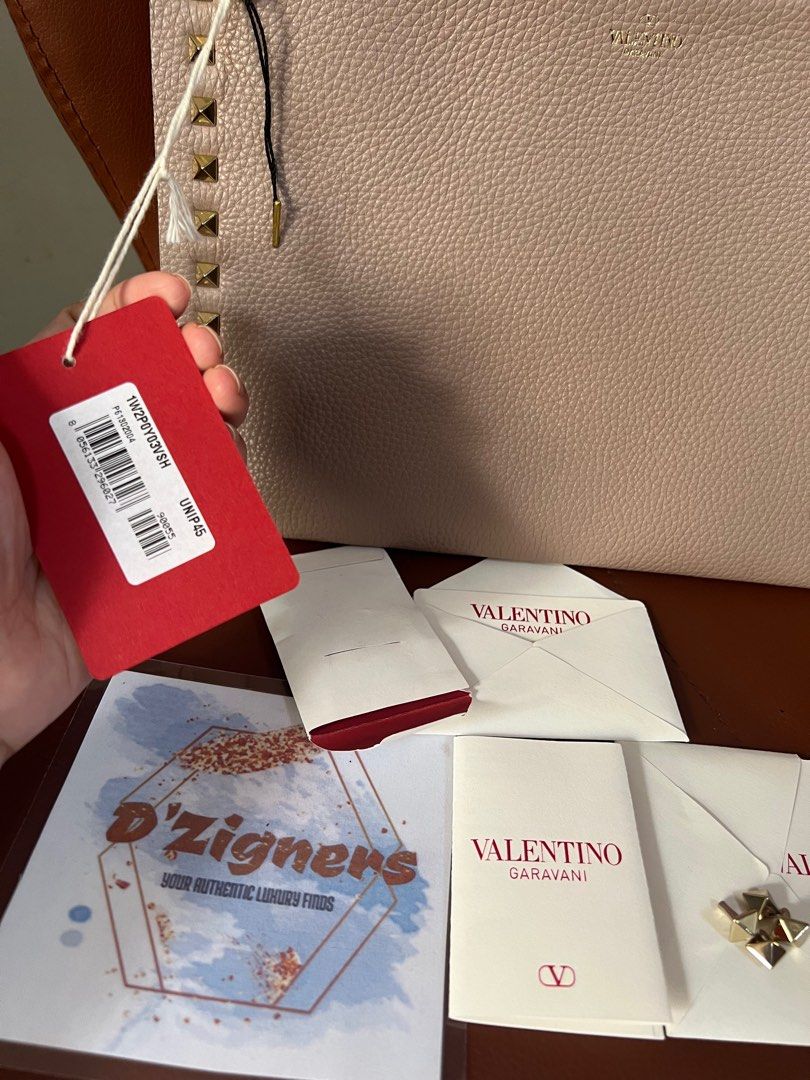Valentino Garavani Studded Pouch (Category: Luxury Bags & Wallets) located in Quezon City. Submitted by DZignersbyZsa (Listing ID 1334995568, Image 3). Description: Authentic Valentino Garavani Studded Pouch unused / like new Comes with cards, extra studs , provided dustbag and box What you see is what you will get 🫰🏼.