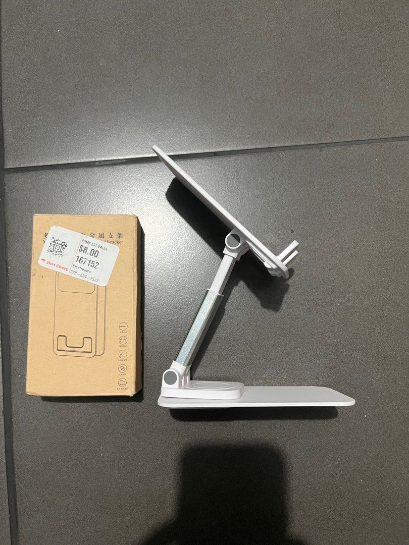 Rotating adjustable phone stand (Category: Mounts & Holders) located in Pasay City. Submitted by thejunkclosetph (Listing ID 1335072792, Image 2). Description: New mobile phone stand Color white Rotates 360 degrees Height can be adjusted.