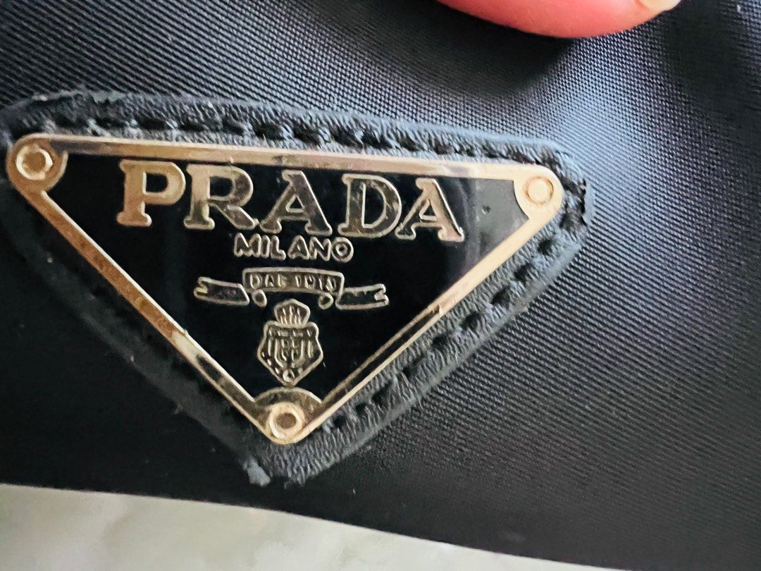 Prada Nylon Logo Jacquard (Category: Luxury Bags & Wallets) located in Indang. Submitted by lornacmtl (Listing ID 1335258735, Image 2). Description: Authentic Prada 2way bag with sling, authenticity card, zipper closure, 2 open pocket & 1 zip pocket, gold hardware, made in Italy (pls see posted pics)no major flaws just sign of used 13”x8”x4” Rfs: decluttering Payment thru Gcash & bank transfer.
