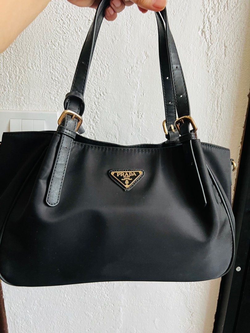 Prada Nylon Logo Jacquard (Category: Luxury Bags & Wallets) located in Indang. Submitted by lornacmtl (Listing ID 1335258735, Image 1). Description: Authentic Prada 2way bag with sling, authenticity card, zipper closure, 2 open pocket & 1 zip pocket, gold hardware, made in Italy (pls see posted pics)no major flaws just sign of used 13”x8”x4” Rfs: decluttering Payment thru Gcash & bank transfer.