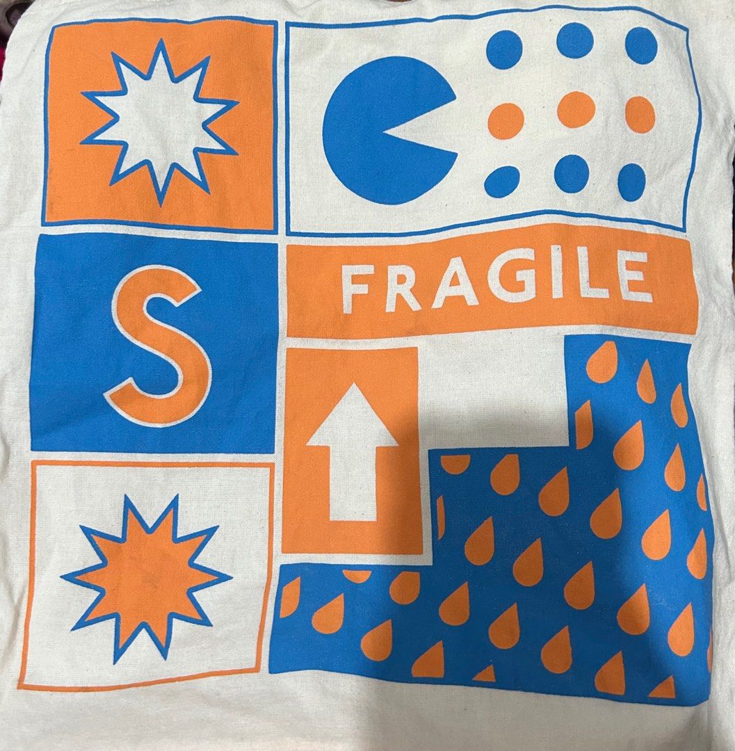 ARTWORK Fragile (Tote Bag) Blue, Orange (Category: Tote Bags) located in Manila. Submitted by shereels (Listing ID 1340926325, Image 2). Description: Be it backpacks, tote bags, string bags, sling bags (you name it!), our bags are made out of high-quality materials that feature witty bold prints that will make you stand out from the rest of the pack. •Material: Cotton-blend fabric Silk-screen printed •Dimensions: Height: 42 cm Top width: 38 cm Bo
