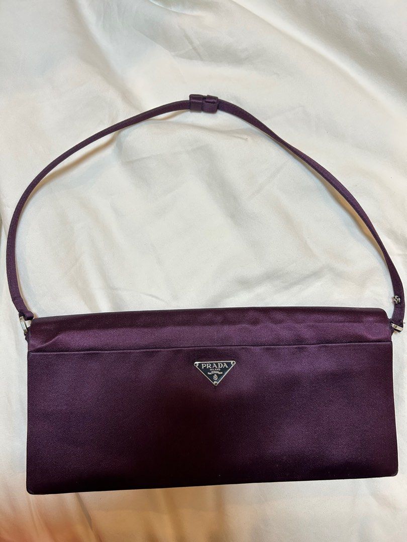 Authentic Prada dark purple silk bag (Category: Luxury Bags & Wallets) located in Pasig City. Submitted by missdierdre (Listing ID 1341175300, Image 2). Description: Prada bag in dark purple silk material for sale. Authentic. Has minor rubs and signs of usage but no major flaws; most notable flaw is the half-detached button on the strap (last photo, encircled) but this is easily fixable. Can be a shoulder bag or a top handle bag, strap is adjusta