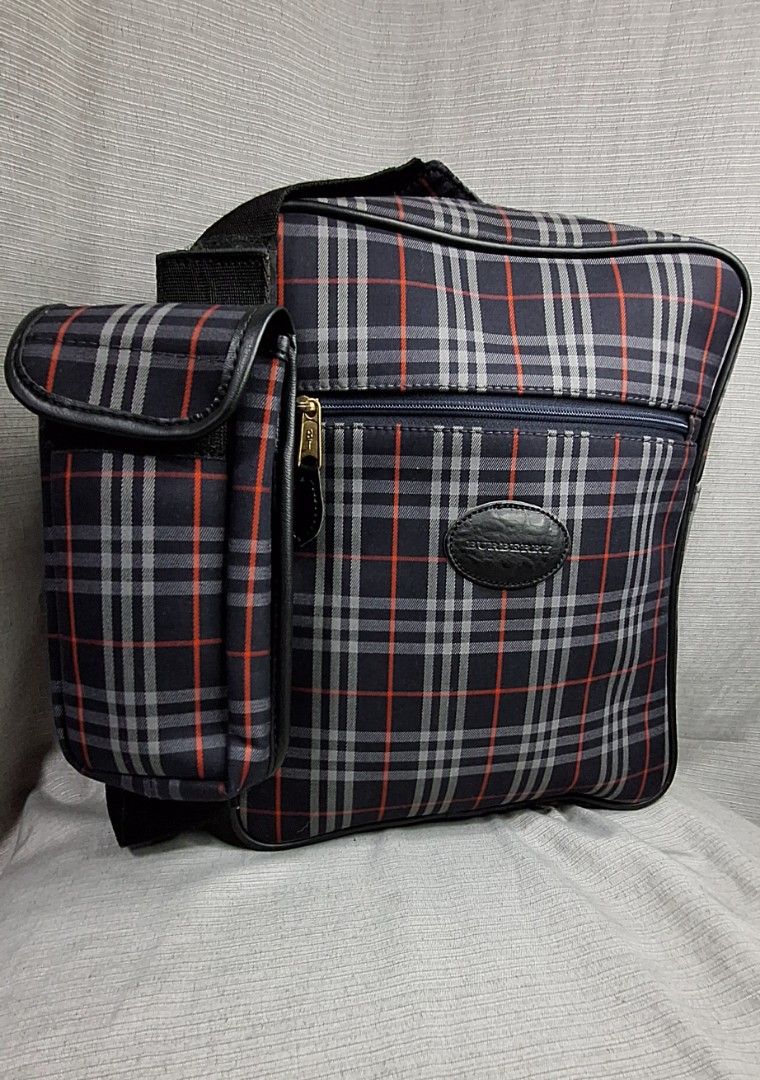 Burberry Crossbody Bag for Men (Category: Luxury Bags & Wallets) located in Pasig City. Submitted by fjrd_relovedluxury28 (Listing ID 1341300842, Image 2). Description: Selling this Authentic, Vintage, pre-loved Burberry Body Bag in Medium. Canvass color is still vibrant with no holes and rubs. Zipper functions well. No cracks on pipings and interior liner. Comes with a Celphone pouch which can fit 6.5inches. Message us for negotiation..