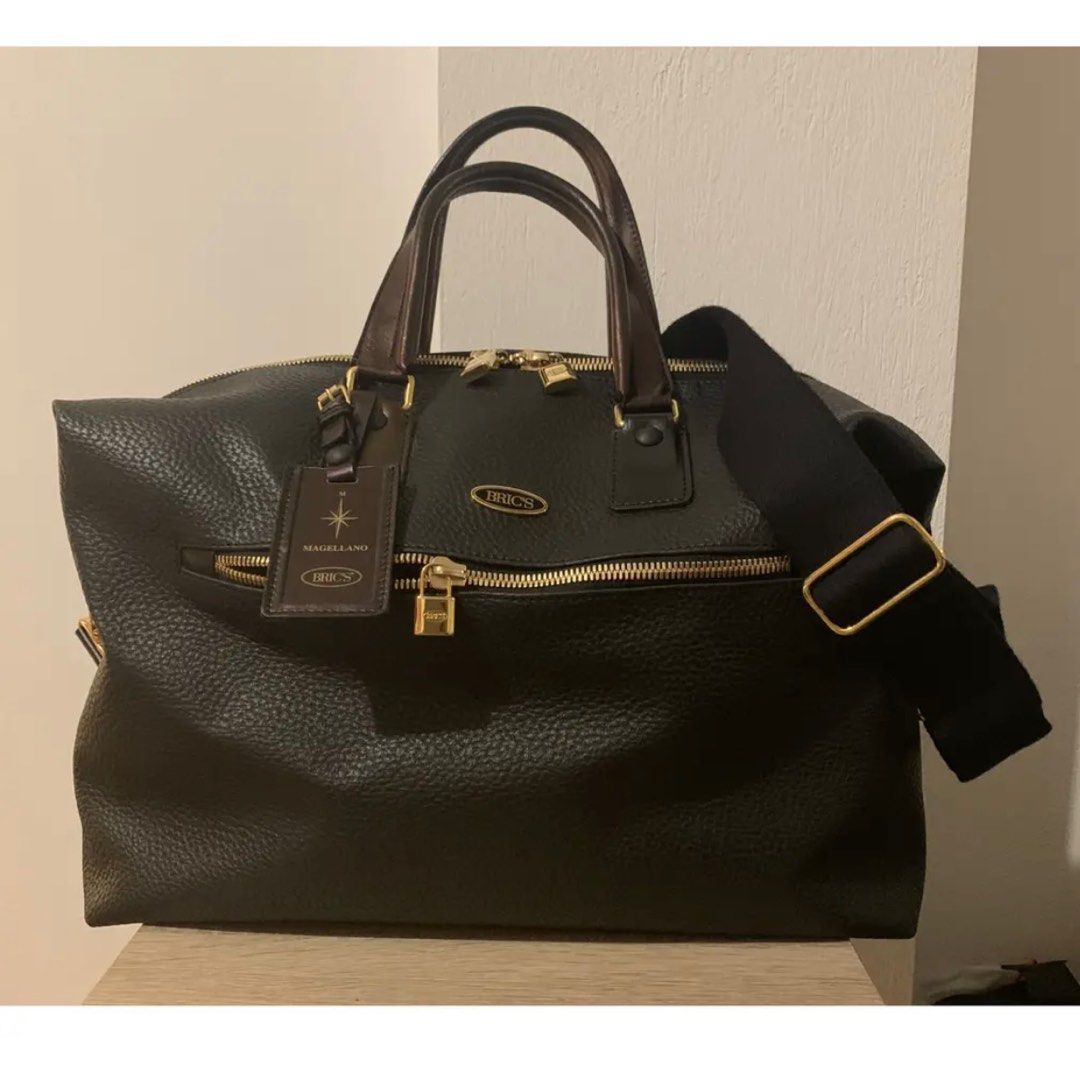 Brics Leather Travel Bag (Category: Bags & Wallets) located in Singapore. Submitted by sherryoncloud9 (Listing ID 1341774909, Image 3). Description: Material: Cowhide, full-grain leather. Leather age-ware signs: the leather is a natural cowhide with some natural stretch marks. Lining: The inner lining is a grosgrain signature canvas, Metal: brass metal gold-tone studs, zip puller, locks, and clasps Features: Outer: One zipped pocket and a securel