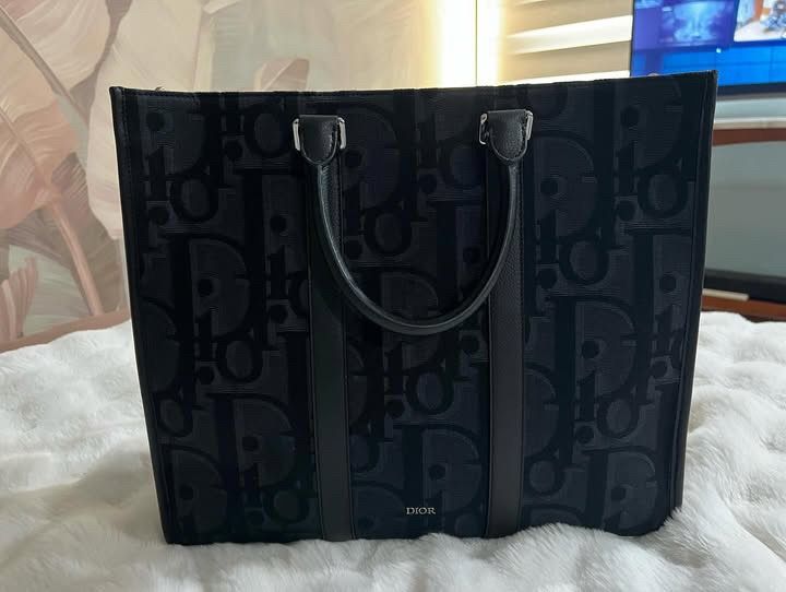 Dior East-West Tote Bag (Category: Luxury Bags & Wallets) located in Makati City. Submitted by clockbykent (Listing ID 1341994697, Image 1). Description: Almost brand-new Bought in Dior, 5th Ave., NYC Everything except of the box (Strap, card, receipt, dust bag) Meet up in Quezon City (Tomas Morato Ave.).