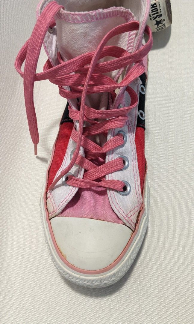 Pink Chuck Taylors High Tops (Category: Sneakers) located in Mandaluyong City. Submitted by clf97 (Listing ID 1342171687, Image 3). Description: Patchwork pink and white chucks, practically no wear on sole. Converse decal starting to peel off from storage. US women size 6. Rubber and fabric still good. Some yellowing with age..