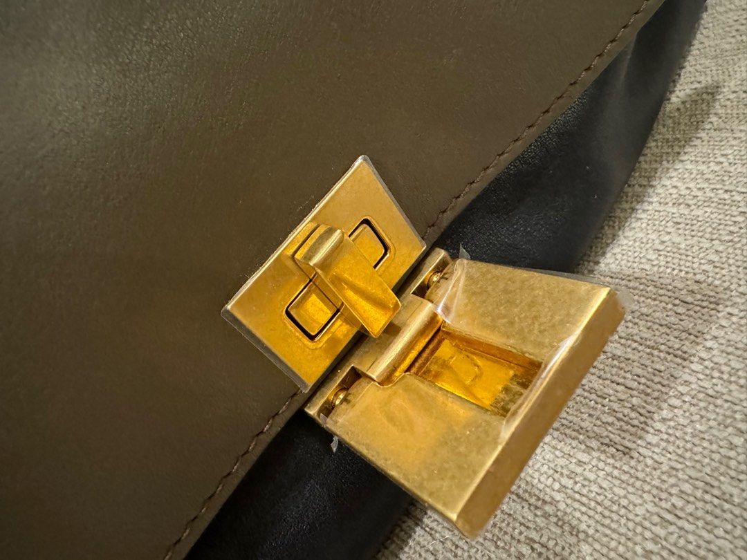 Celine Trapeze (Category: Luxury Bags & Wallets) located in Quezon City. Submitted by newbieandoldie (Listing ID 1342448471, Image 3). Description: Bag lock hardware newly changed (Still with stickers & receipt of repair from celine hk) RFS : decluttering Comes with dust bag & receipt .