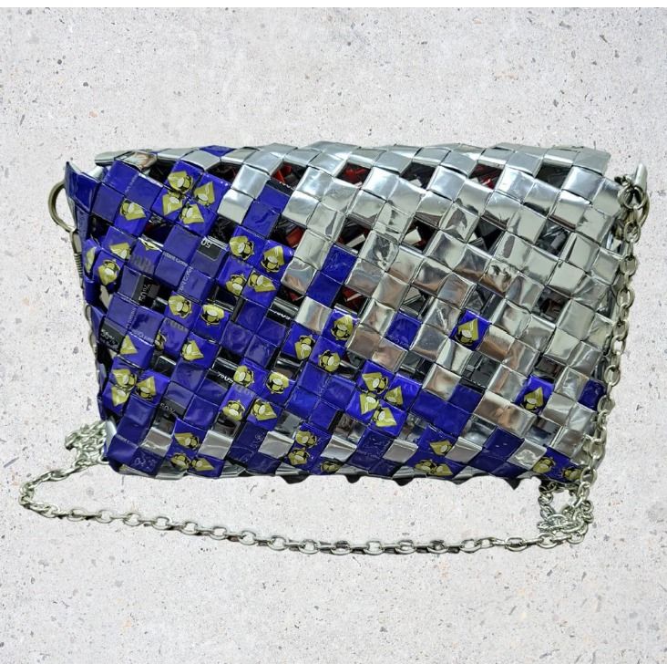 Cobalt Gleam (Category: Cross-body Bags) located in Singapore. Submitted by bcaresg (Listing ID 1342402348, Image 2). Description: Clutch with sling made from recycled materials Dimensions: W: 19 cm, H: 12 cm Add a pop of color to your look with this vibrant, handmade upcycled crossbody bag! Featuring a stunning mix of royal blue and metallic silver, this bag is crafted with care from drink packaging, transforming waste into a fashion-forward acc
