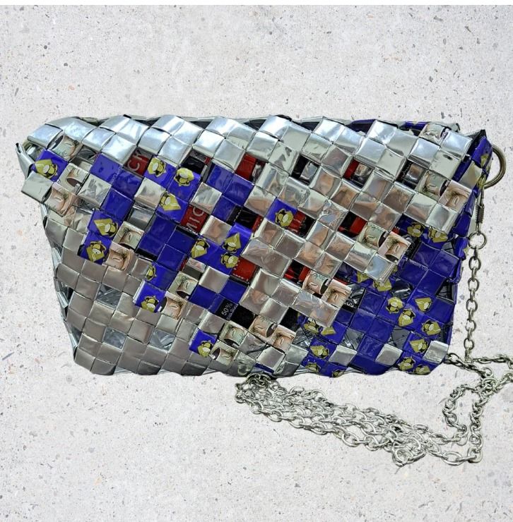 Cobalt Gleam (Category: Cross-body Bags) located in Singapore. Submitted by bcaresg (Listing ID 1342402348, Image 1). Description: Clutch with sling made from recycled materials Dimensions: W: 19 cm, H: 12 cm Add a pop of color to your look with this vibrant, handmade upcycled crossbody bag! Featuring a stunning mix of royal blue and metallic silver, this bag is crafted with care from drink packaging, transforming waste into a fashion-forward acc