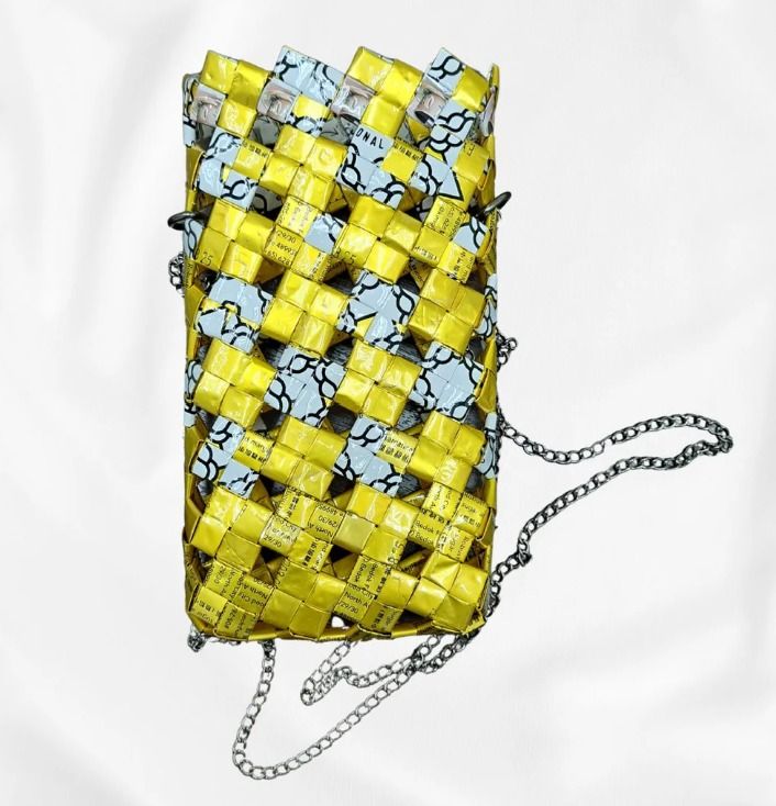 Golden Gleam (Category: Purses & Pouches) located in Singapore. Submitted by bcaresg (Listing ID 1342416804, Image 1). Description: Handphone pouch with sling made from recycled materials Dimensions:40 W: 10.5 cm, H: 18 cm This pouch is handcrafted from recycled materials in a vibrant yellow and blue woven design. Featuring a convenient chain strap, it's perfect for carrying your phone and small essentials in sustainable style. This bag is loving