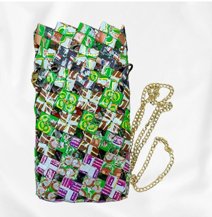 Milo Magic (Category: Cross-body Bags) located in Singapore. Submitted by bcaresg (Listing ID 1342398204, Image 1). Description: Handphone pouch with sling made from recycled materials Dimensions: W: 10.5 cm, H: 18 cm Looking for a phone pouch that's sustainable? Check out this handmade, upcycled phone pouch crafted from colorful drink packaging materials like Milo! Each piece is carefully woven to create a one-of-a-kind design that adds fun, per