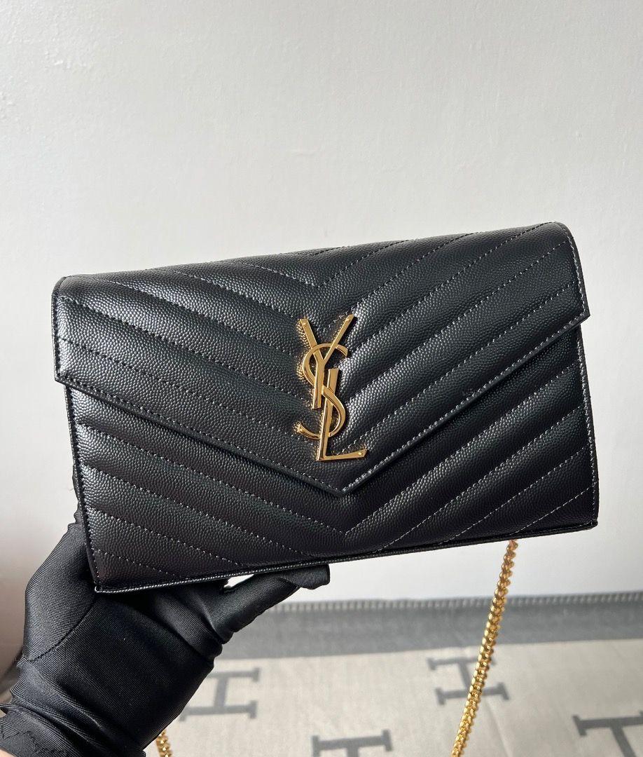 YSL Cassandre Chain Wallet in Black Grained Leather Bag (Category: Luxury Bags & Wallets) located in Antipolo. Submitted by chanchimj (Listing ID 1342348645, Image 1). Description: TIMELESS CHAIN PURSE WITH CASSANDRE EMBELLISHMENT AND ICONIC CHEVRON QUILTING. THIS PRACTICAL ACCESSORY FEATURES TWO LARGE COMPARTMENTS, A ZIPPER POCKET AND CARD SLOTS. IT CAN BE CARRIED IN THE HAND AS A CLUTCH OR ON THE SHOULDER WITH ITS DETACHABLE CHAIN. DIMENSIONS: 